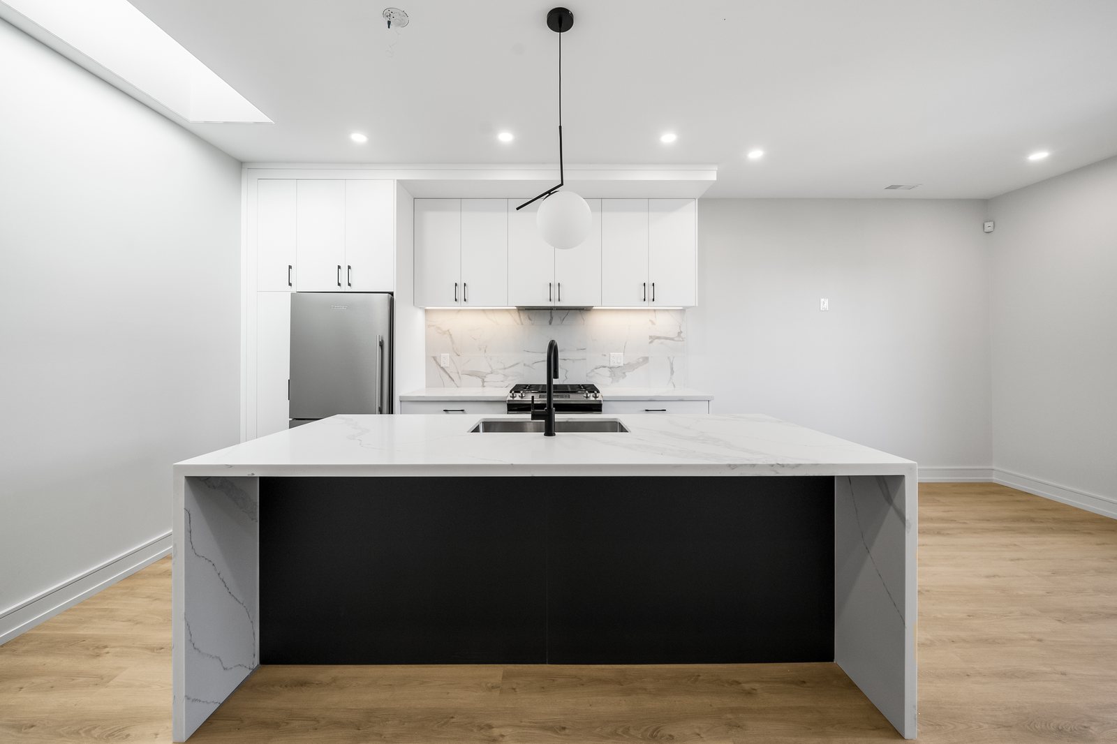 Modern kitchen with waterfall island in a Reside Properties multiplex